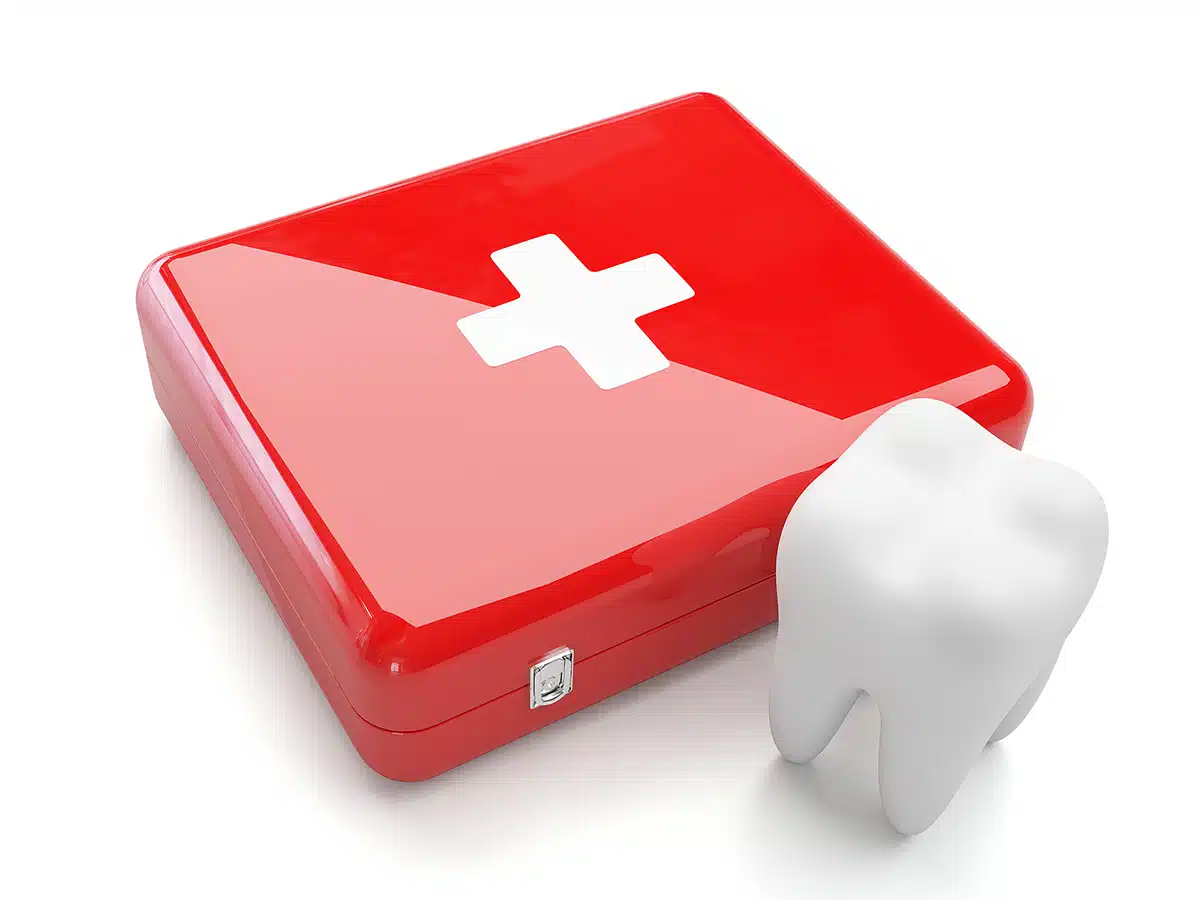 3d tooth with first aid kit isolated on white background